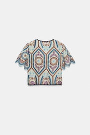 Top court à broderies ajourées