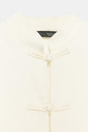Top satiné à brandebourgs