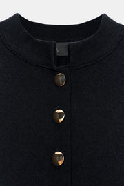 Veste en maille peplum à bouton doré